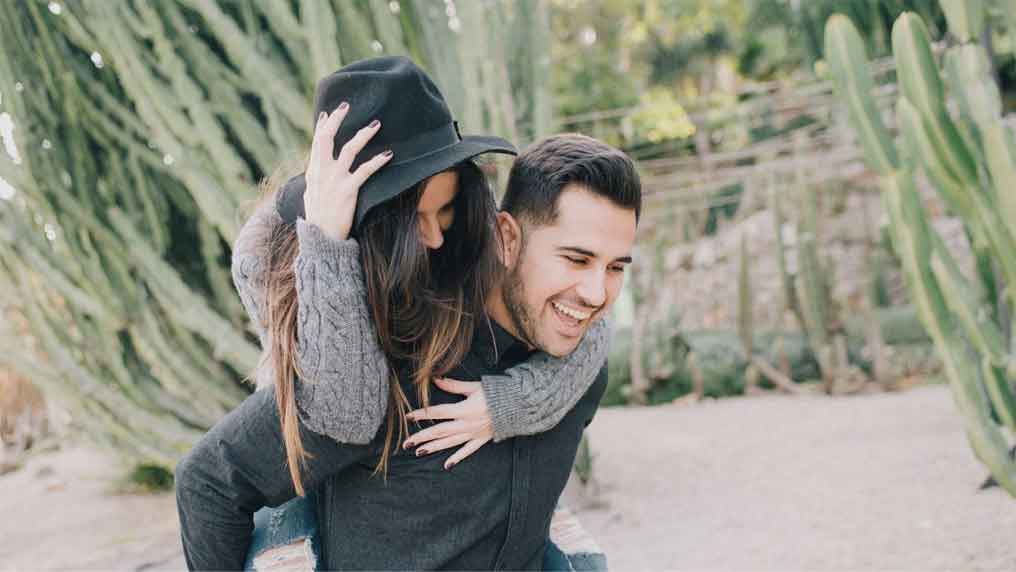 A man carrying a woman on his back.